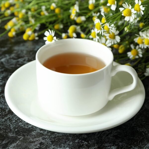 cup-of-chamomile-tea-on-black-smokey-table-2021-09-03-17-16-15-utc-min